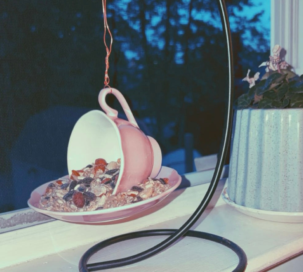 Pink tea cup bird feeder for garden